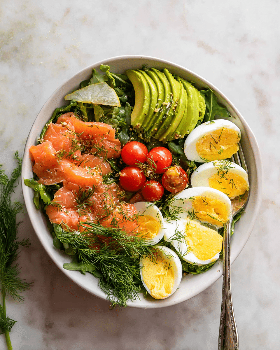 A white bowl filled with a colorful salad sits on a white marbled surface. The bottom layer is dark green leafy arugula, topped with thin slices of pink smoked salmon spread around the bowl. On one side, there is a fan of bright green avocado slices. Hard-boiled eggs cut in halves with soft yellow yolks are placed evenly over the salmon. In the center, a small bunch of shiny red cherry tomatoes adds a pop of color. Sprigs of fresh green dill are scattered on top, with a lemon wedge resting near the eggs. A silver fork is placed inside the bowl on the right side. Photo taken with an iphone --ar 4:5 --v 7