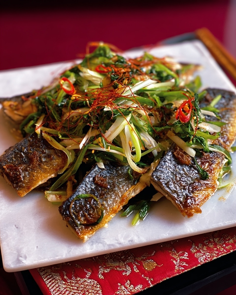 The image shows a white square plate holding three pieces of cooked fish with crispy, golden-brown skin. On top of the fish, there is a mix of thinly sliced green herbs, light green and white onion strips, and some thin, curly red chili threads adding color and texture. The fish pieces are laid flat, overlapping slightly, with the fresh, bright vegetable garnish spread evenly over the top. The plate is placed on a white marbled surface with a red patterned cloth partially visible underneath. Photo taken with an iphone --ar 4:5 --v 7