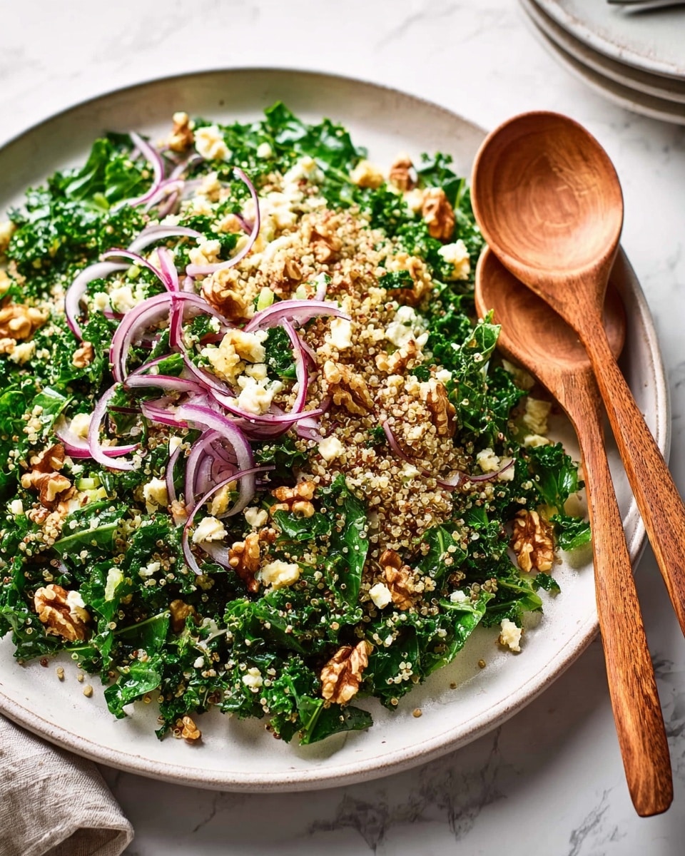 A white plate holds a fresh salad made of chopped dark green leafy vegetables as the base layer, mixed with small grains of light beige quinoa evenly spread throughout. Thin, curved slices of purple red onion are scattered on top, adding color contrast. Small clusters of light yellow cauliflower pieces and chunks of brown walnuts are sprinkled over the salad, adding texture and depth. Two wooden salad utensils rest on one edge of the plate. The plate sits on a white marbled surface. photo taken with an iphone --ar 4:5 --v 7