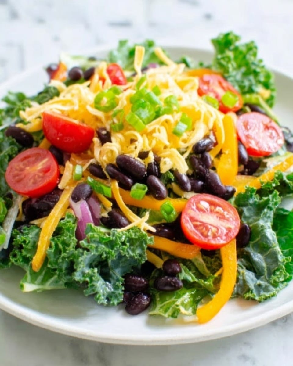 A white plate on a white marbled surface holds a colorful salad made of multiple layers. The bottom layer is dark green kale leaves with a rough texture. On top, there are small black beans scattered around, followed by a layer of thin, bright yellow shredded cheese. Slices of red tomato and orange bell pepper strips are arranged across the salad. Finally, fresh green herbs are sprinkled on top, adding a fresh look. The overall image is bright and fresh, photo taken with an iphone --ar 4:5 --v 7