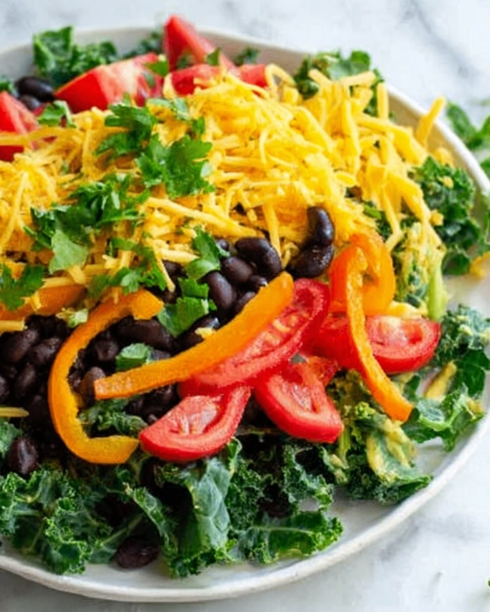 A white plate holds a fresh salad with several layers: a base of dark green curly kale leaves, topped with slices of red cherry tomatoes, black beans scattered throughout, thin strips of bright orange bell pepper, and a sprinkle of shredded yellow cheese. The salad is garnished with small pieces of green onion on top. The background is a white marbled surface. Photo taken with an iphone --ar 4:5 --v 7